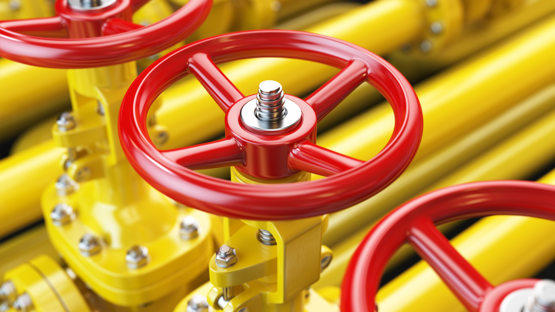 Gelbe Gasleitungen mit einem roten Absperrventil.